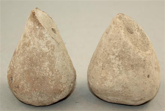 A pair of Greek stone loom weights, c.3rd century BC, 8.5cm and 9.5cm